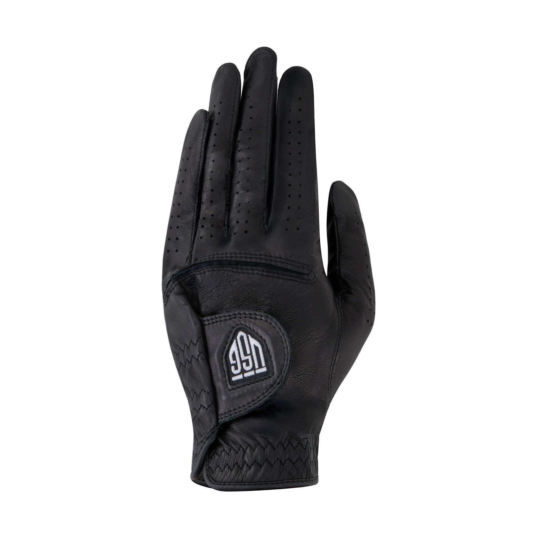 Ultima – Soft Fit Golf Glove in black leather with perforated fingers, woven-texture panels, and an adjustable wrist tab